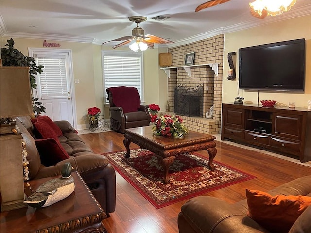 living room featuring crown molding, wood finished floors, visible vents, and ceiling fan