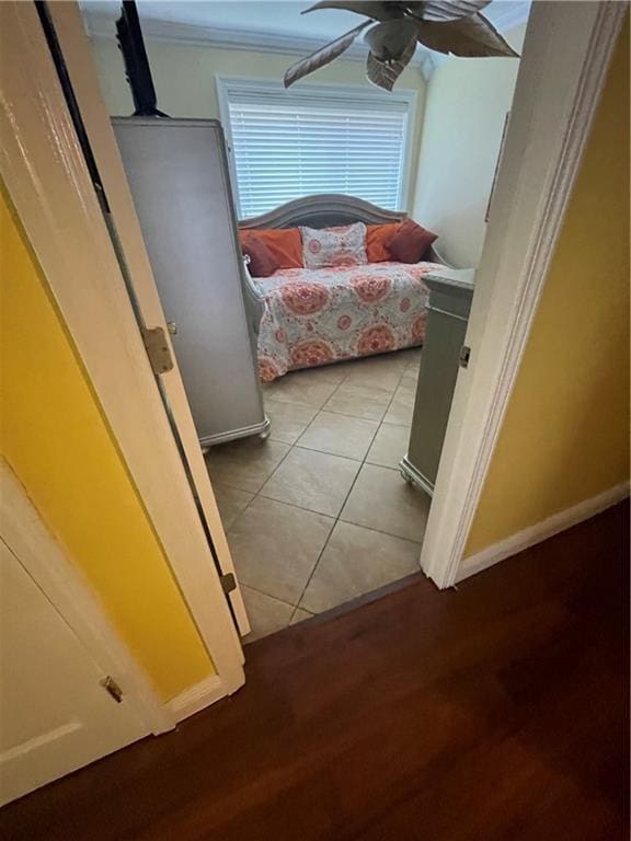 bedroom featuring light tile patterned floors, baseboards, and ceiling fan