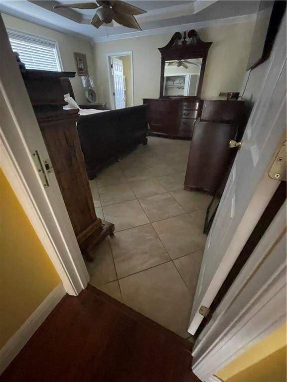 bathroom with tile patterned flooring, baseboards, crown molding, and a ceiling fan