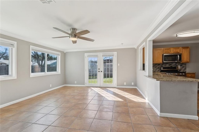 interior space featuring ceiling fan, baseboards, ornamental molding, french doors, and light tile patterned flooring