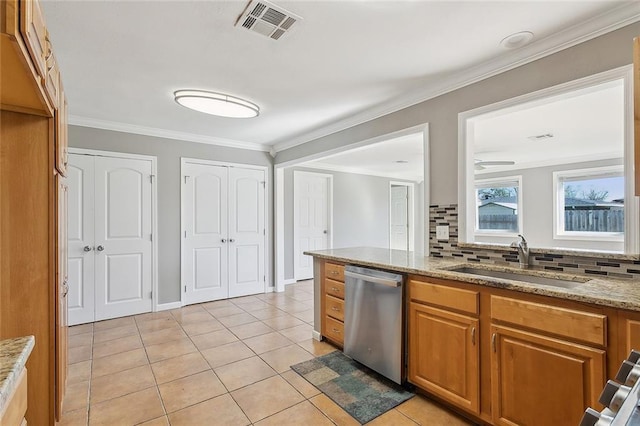 kitchen featuring light stone countertops, visible vents, a sink, stainless steel dishwasher, and crown molding