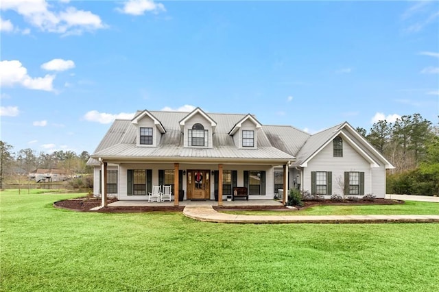 view of front of home with a front lawn, covered porch, and metal roof