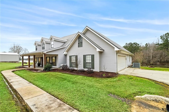 view of front of home with a front yard, a porch, central AC, concrete driveway, and a garage