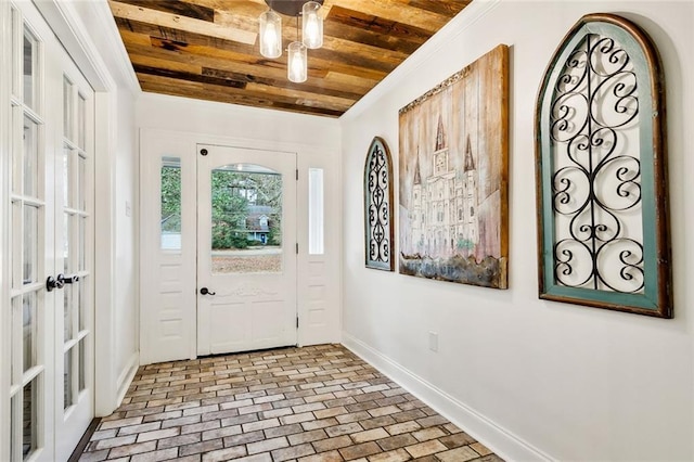 entryway featuring wooden ceiling, french doors, brick floor, and baseboards