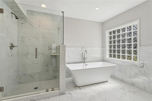 full bathroom with recessed lighting, a freestanding bath, marble finish floor, and a stall shower