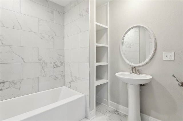 full bath with marble finish floor, baseboards, and a sink