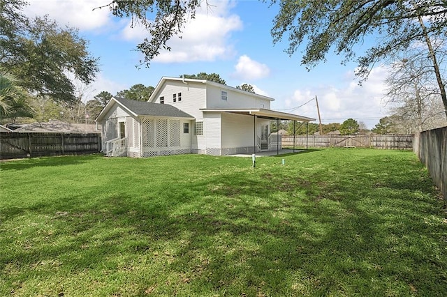 back of house featuring a lawn, a patio, a fenced backyard, and an attached carport