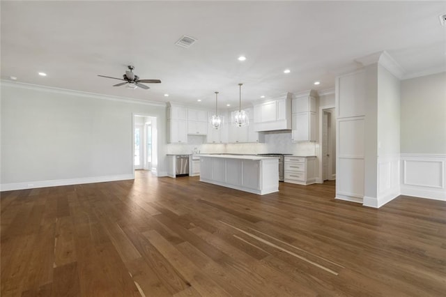 kitchen with visible vents, a center island, open floor plan, light countertops, and white cabinets