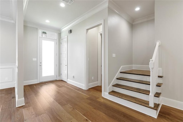 foyer with ornamental molding, hardwood / wood-style flooring, recessed lighting, baseboards, and stairs