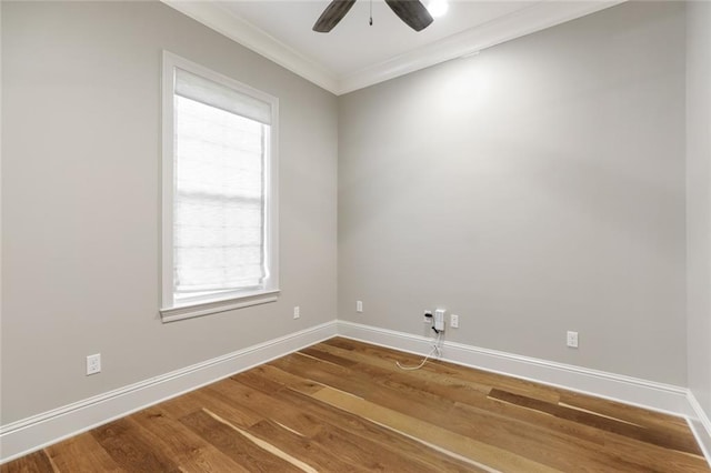 unfurnished room featuring baseboards, wood finished floors, a ceiling fan, and ornamental molding