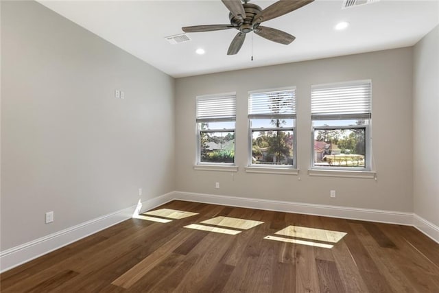 unfurnished room with visible vents, recessed lighting, baseboards, and wood finished floors