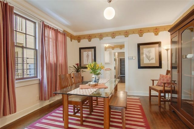 dining space featuring wood finished floors, baseboards, and a wealth of natural light