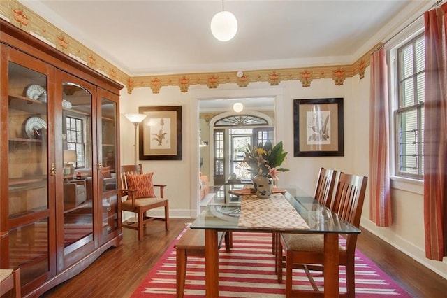 dining area with french doors, plenty of natural light, baseboards, and dark wood-style flooring