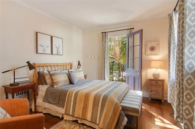 bedroom featuring wood finished floors, baseboards, and ornamental molding