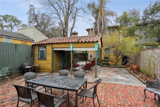 view of patio with a fenced backyard and outdoor dining space