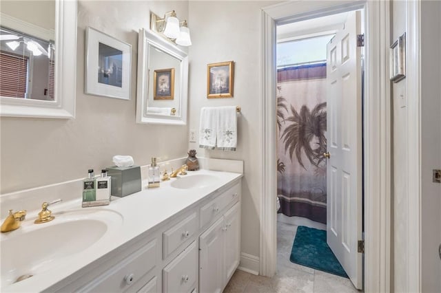 full bathroom featuring double vanity, tile patterned floors, and a sink