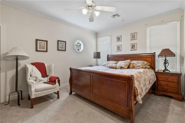 bedroom with light carpet, visible vents, crown molding, and baseboards