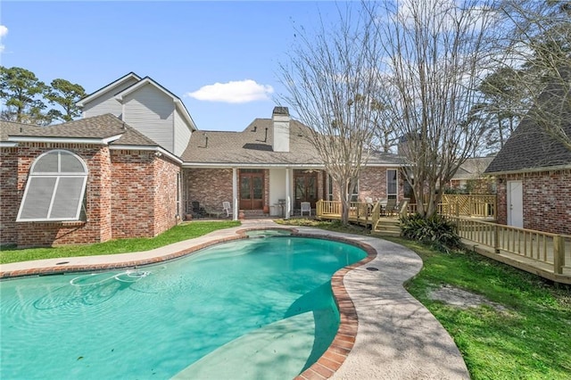 view of swimming pool featuring a fenced in pool and a wooden deck