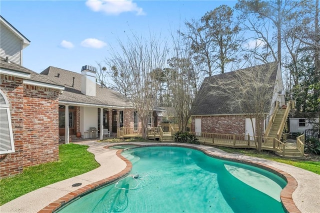 view of swimming pool featuring a fenced in pool and a wooden deck