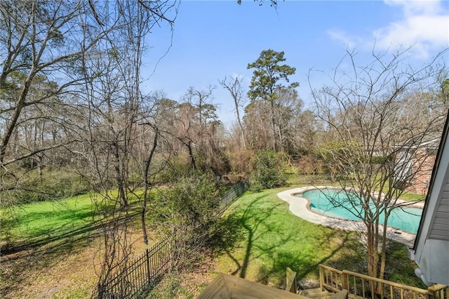 pool featuring a lawn and fence