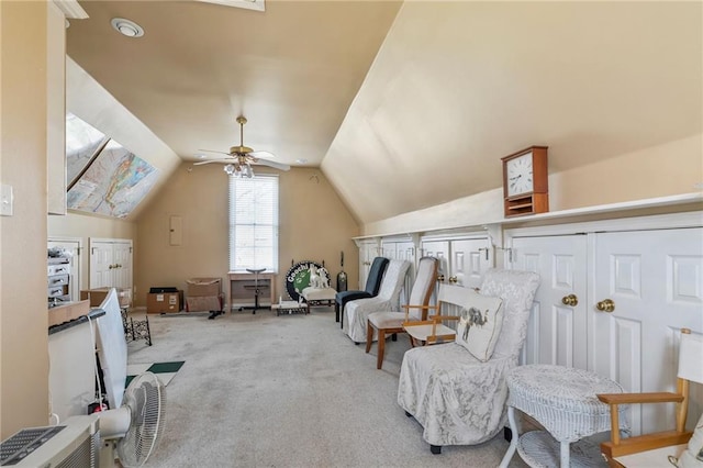 sitting room with a ceiling fan, carpet, and lofted ceiling