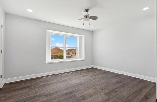 spare room with a ceiling fan, recessed lighting, dark wood-style floors, and baseboards