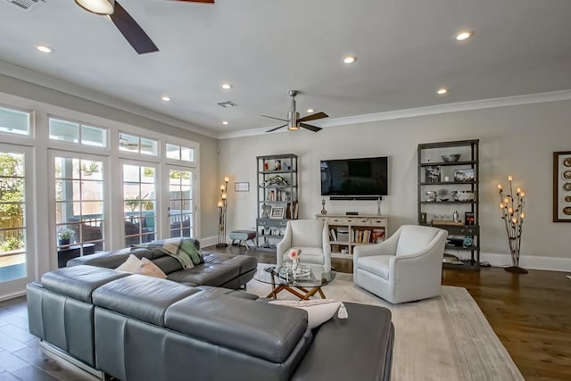 living room with crown molding, a ceiling fan, and wood finished floors