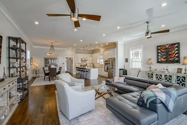 living area with ornamental molding, dark wood-style floors, recessed lighting, and ceiling fan