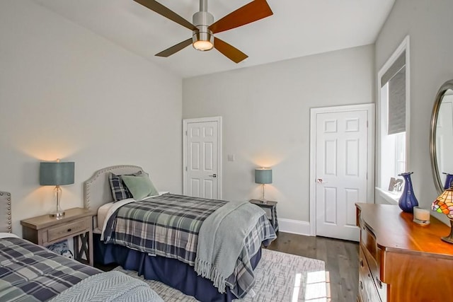 bedroom with dark wood-style floors, baseboards, and ceiling fan