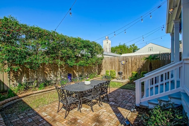 view of patio with a fenced backyard and outdoor dining space