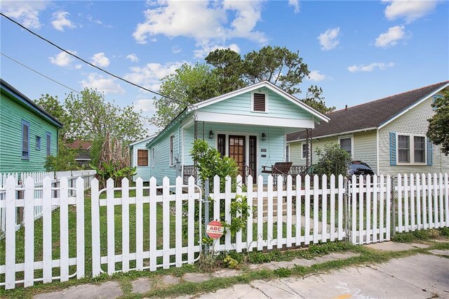 view of front of home featuring a fenced front yard and a porch