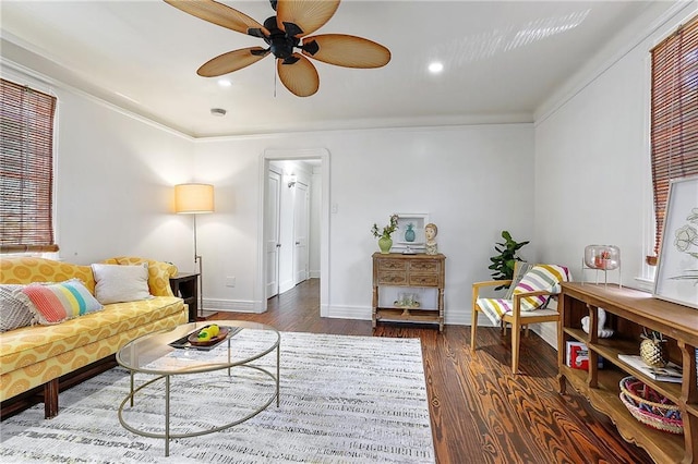 living room with ceiling fan, baseboards, wood finished floors, and ornamental molding