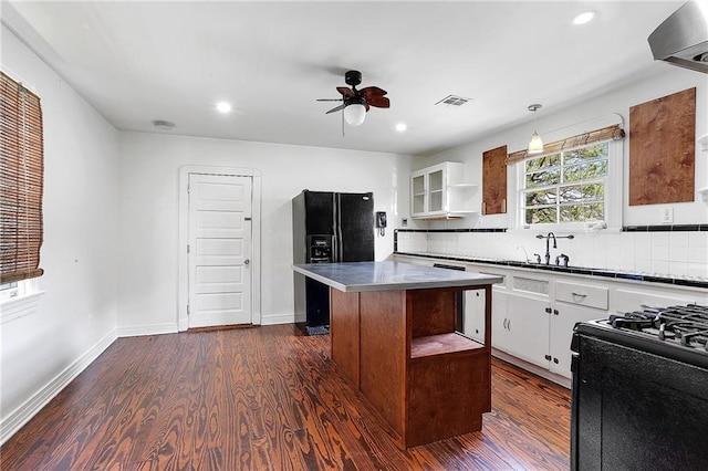 5515 Dauphine St, New Orleans, LA 70117 - kitchen with visible vents, open shelves, black appliances, a ceiling fan, and dark wood-style flooring