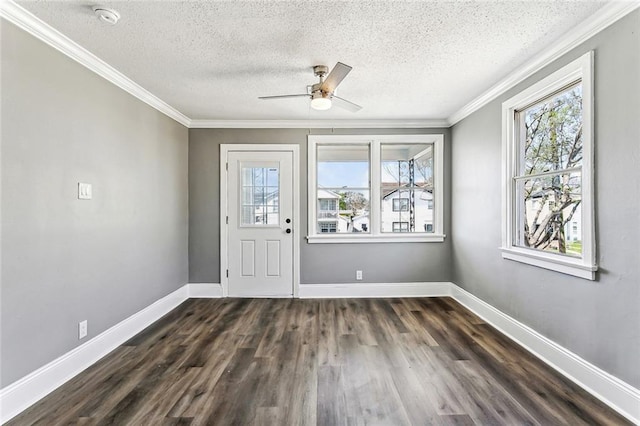 entrance foyer featuring crown molding, ceiling fan, baseboards, dark wood finished floors, and a textured ceiling