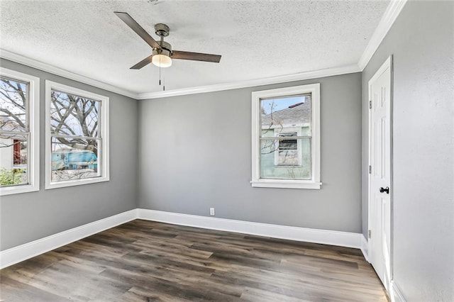 empty room featuring baseboards, dark wood-type flooring, ornamental molding, and a textured ceiling