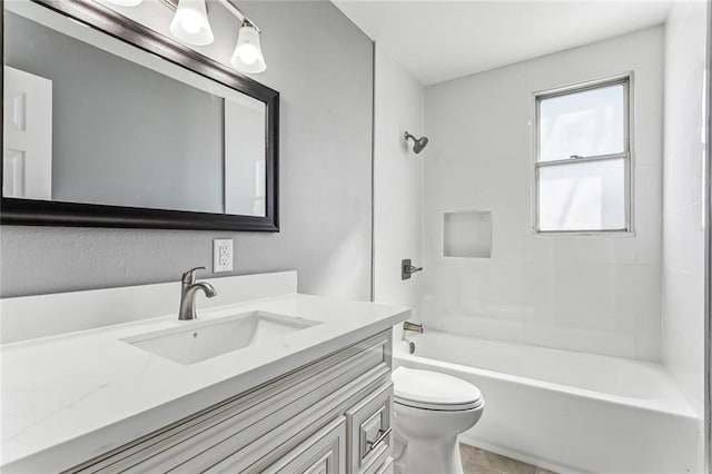 bathroom featuring washtub / shower combination, toilet, and vanity