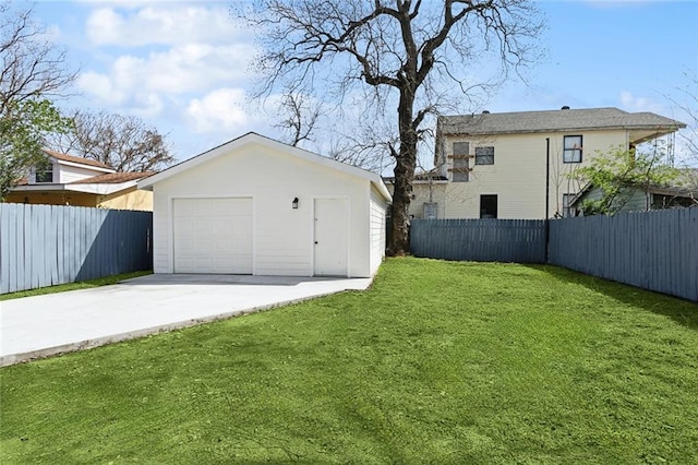 detached garage featuring driveway and fence