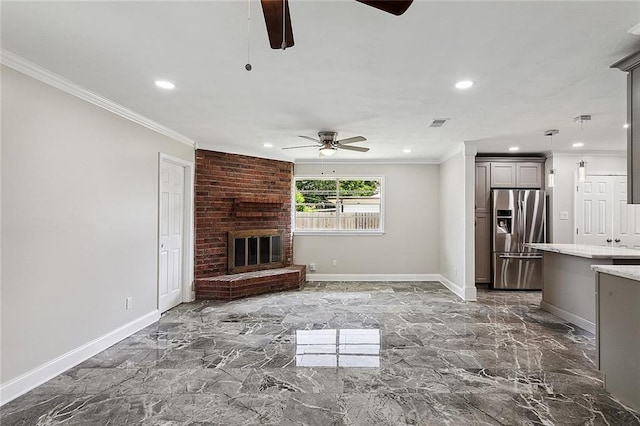 unfurnished living room with marble finish floor, a fireplace, crown molding, and baseboards