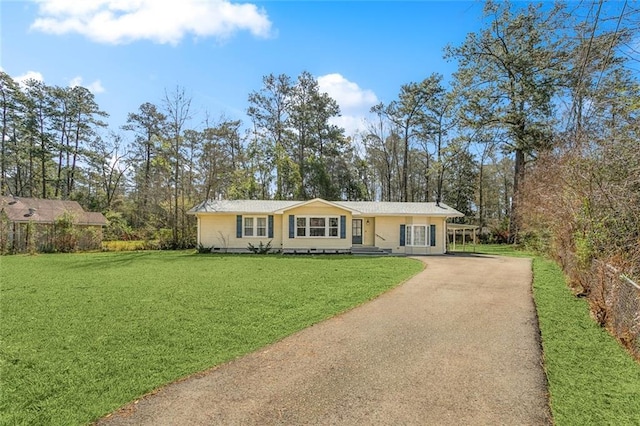 ranch-style house featuring aphalt driveway, a front yard, and crawl space