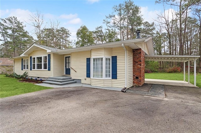 ranch-style house with aphalt driveway, crawl space, and a front lawn