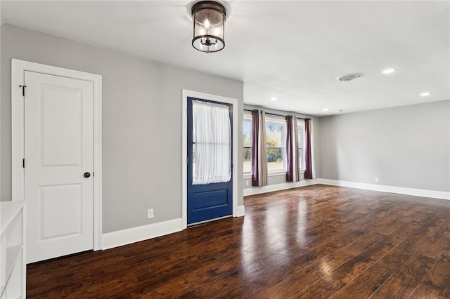 unfurnished room featuring hardwood / wood-style floors, recessed lighting, visible vents, and baseboards