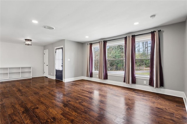 unfurnished room featuring visible vents, recessed lighting, baseboards, and wood finished floors