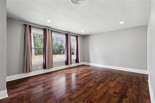 empty room featuring recessed lighting, visible vents, baseboards, and wood finished floors