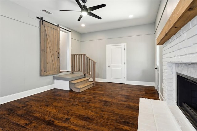 interior space with stairs, wood finished floors, baseboards, and a ceiling fan