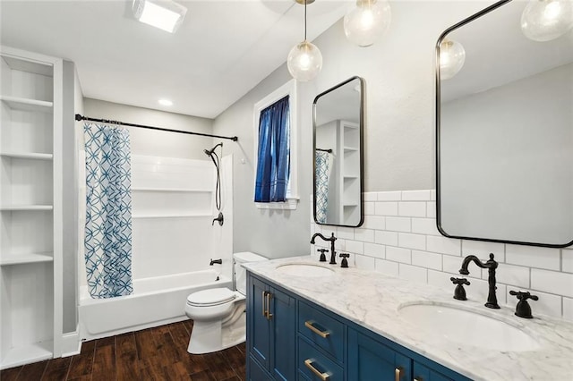 full bath with a sink, shower / bath combo with shower curtain, tasteful backsplash, and wood finished floors