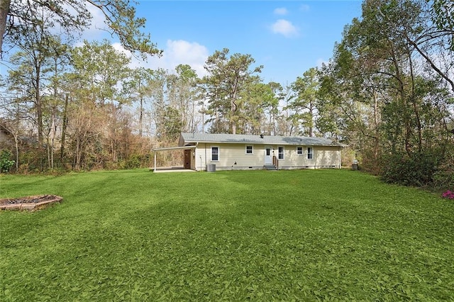 view of yard with an attached carport and cooling unit