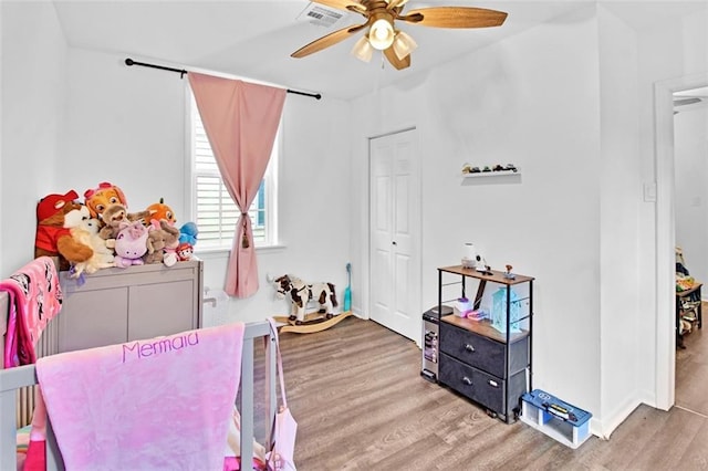 bedroom with visible vents, ceiling fan, and wood finished floors