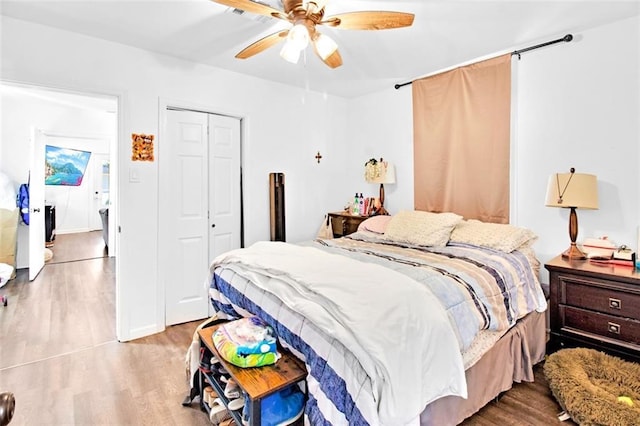 bedroom with a closet, ceiling fan, and wood finished floors