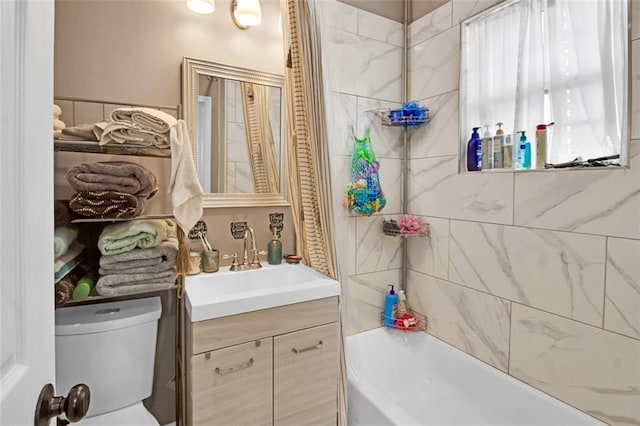 full bathroom featuring toilet, vanity, and washtub / shower combination