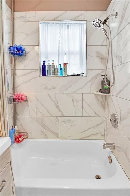 bathroom with vanity and washtub / shower combination